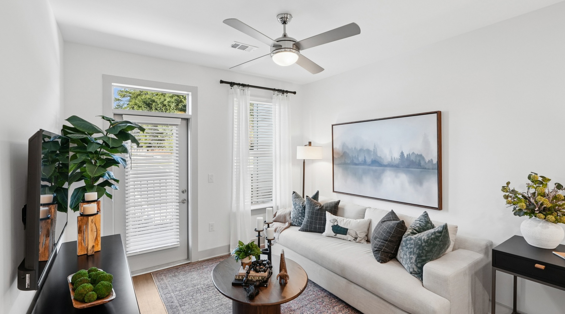 a living room with a fan and a couch