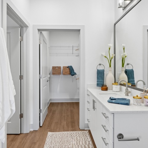 a spacious bathroom with a large mirror and ample light